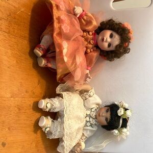 Set of 2 designer made ( stamped on back n #s  8” sitting porcelain dolls